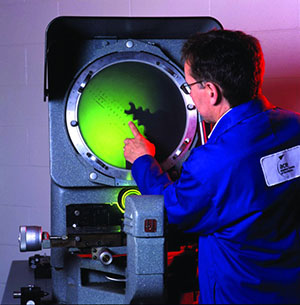 A researcher from the Aviation Centre of Excellence, Confederation College, in Thunder Bay, Ontario working with equipment.
