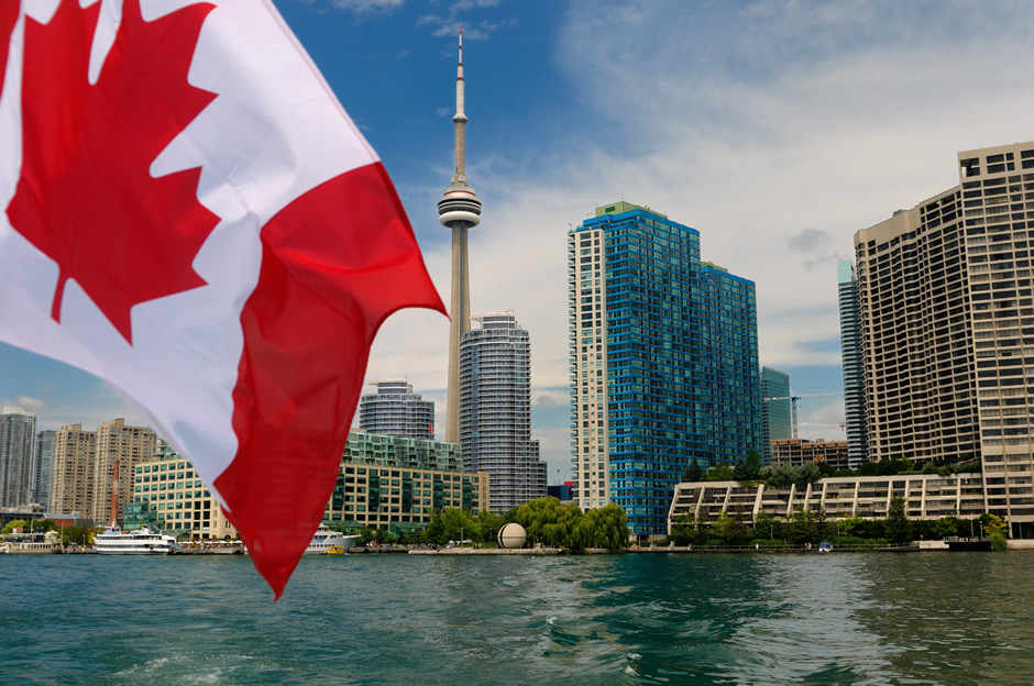 Toronto's lakeshore as observed on a boat. The Canadian Flag is flying.