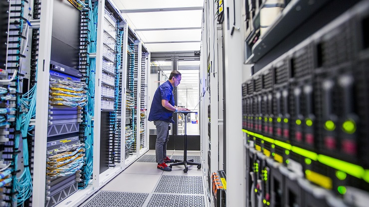 A worker checking the stats on the data storage system at the Data Science Coalition facility
