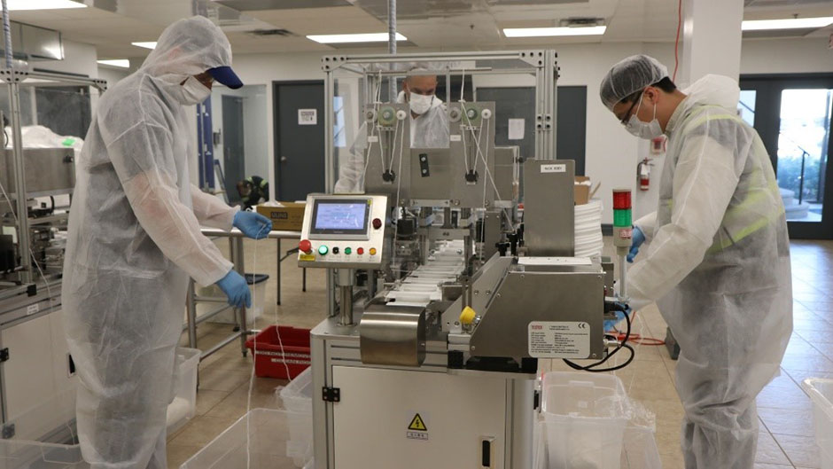 Two Martinrea workers in a sterile manufacturing environment