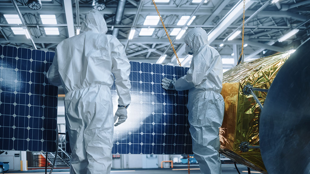 team of scientists fixing solar panel wings