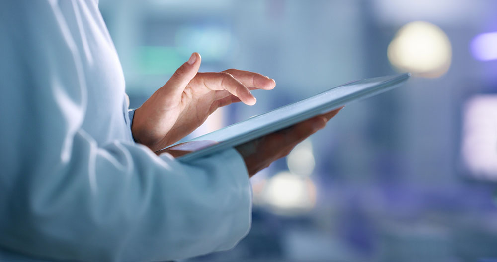 Medical professional using a tablet