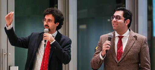 CEO Amir Hoss and CTO Mahdi Marsousi, wearing suits and standing and holding microphones